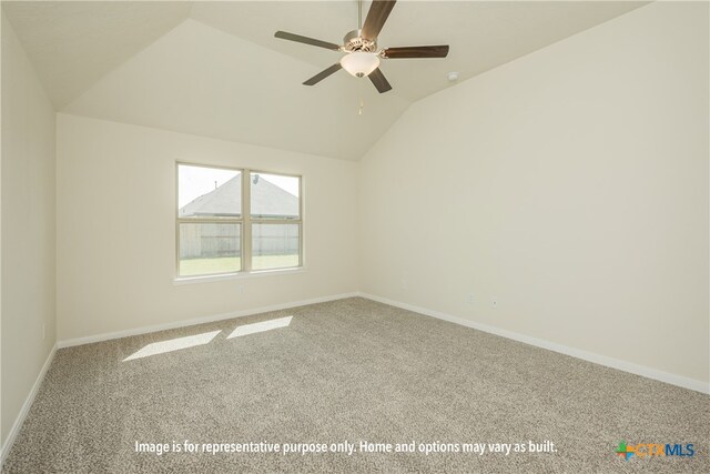 spare room with a ceiling fan, lofted ceiling, carpet flooring, and baseboards