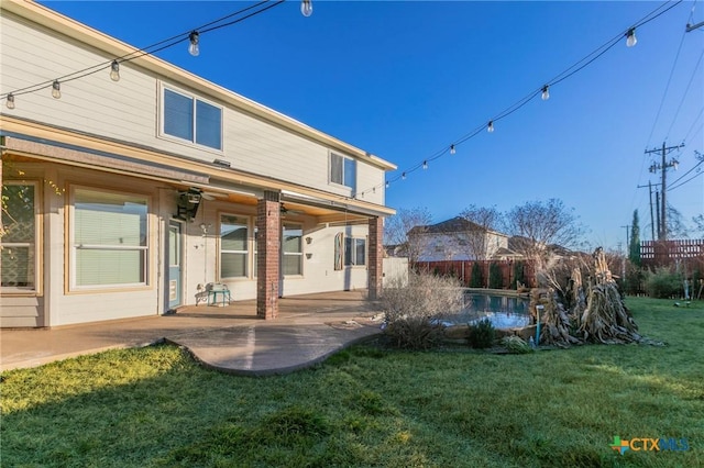 back of property featuring a patio, a yard, and fence