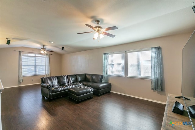 living area with lofted ceiling, baseboards, a ceiling fan, and dark wood-type flooring