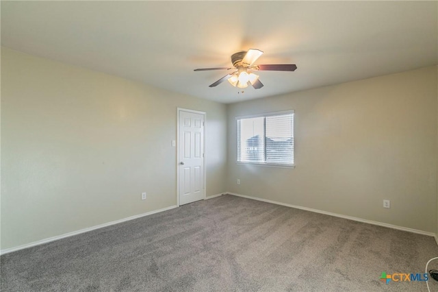 unfurnished room featuring a ceiling fan, carpet, and baseboards