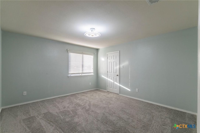 spare room with carpet flooring and baseboards