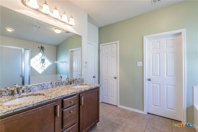 full bath with double vanity, visible vents, a sink, and tile patterned floors