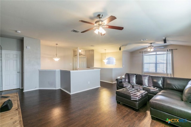 living area with a ceiling fan, dark wood-style flooring, visible vents, and baseboards