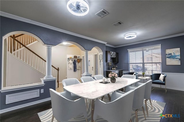 dining space featuring arched walkways, ornamental molding, visible vents, and ornate columns