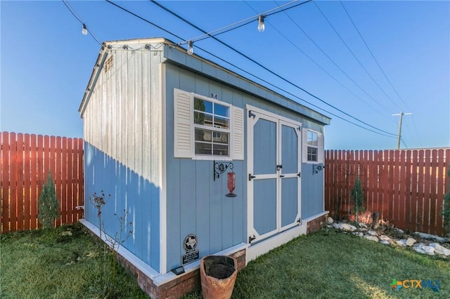 view of shed featuring a fenced backyard