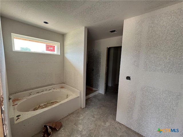 6001 Aquilla Dr, Killeen, TX 76542 - full bath with a garden tub, a shower stall, and a textured ceiling