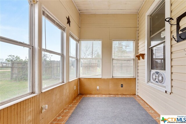 unfurnished sunroom featuring wooden ceiling