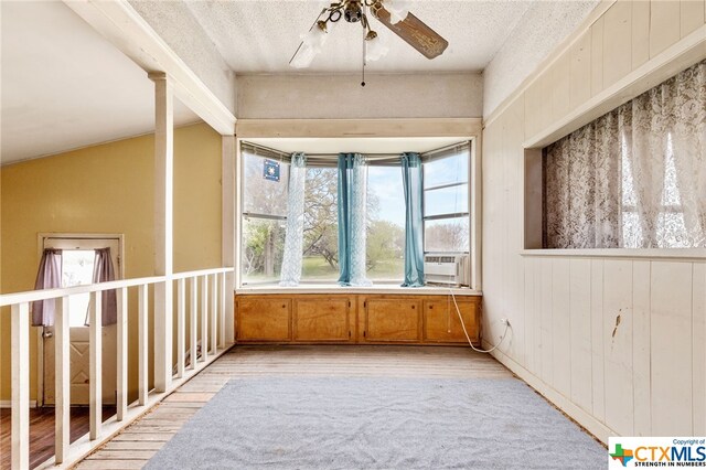 unfurnished sunroom featuring ceiling fan and vaulted ceiling