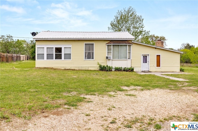 rear view of house with a lawn