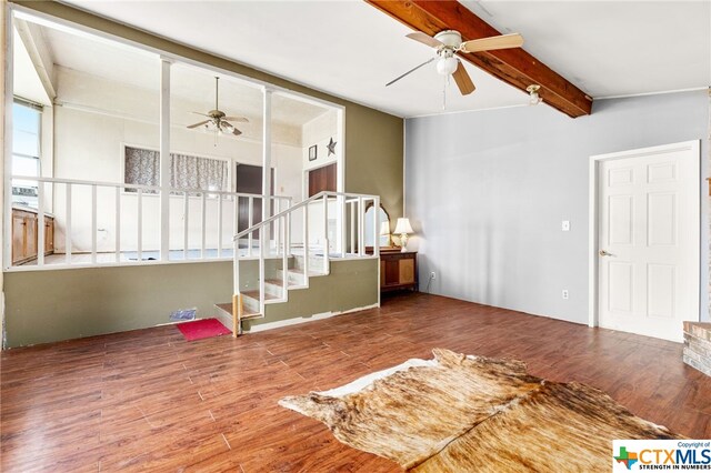 unfurnished living room featuring lofted ceiling with beams, wood-type flooring, and ceiling fan