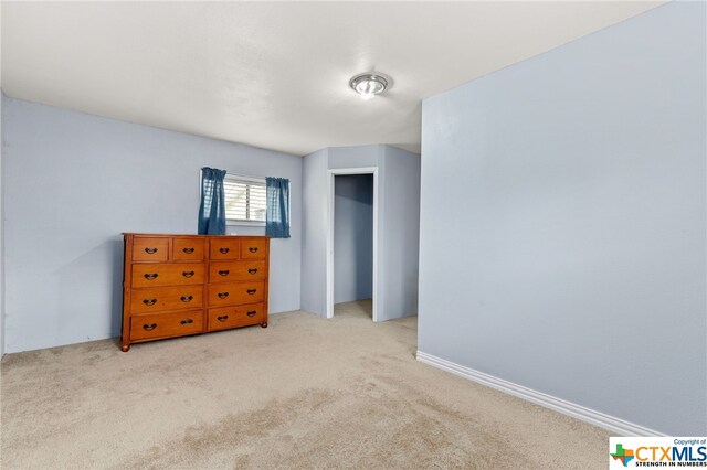 unfurnished bedroom featuring light colored carpet