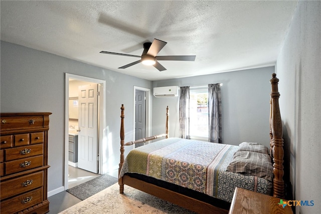 bedroom featuring a wall mounted air conditioner, a textured ceiling, ceiling fan, and ensuite bathroom