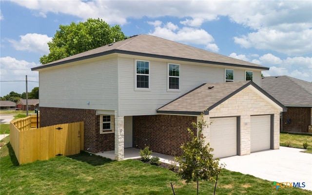 view of front facade with a front yard and a garage