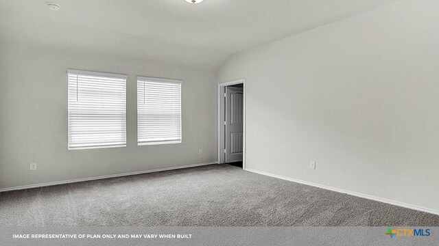 carpeted spare room with lofted ceiling