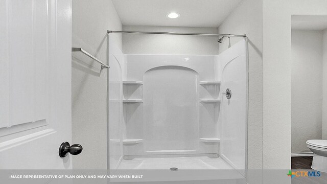 bathroom with a shower and toilet