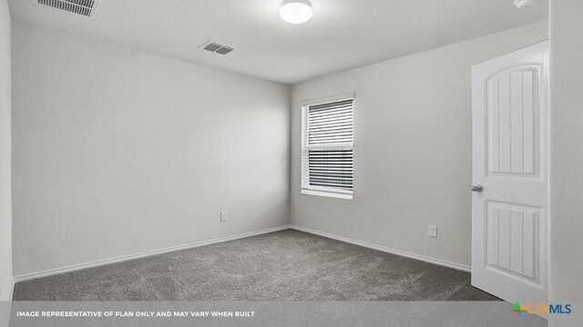 spare room with dark carpet