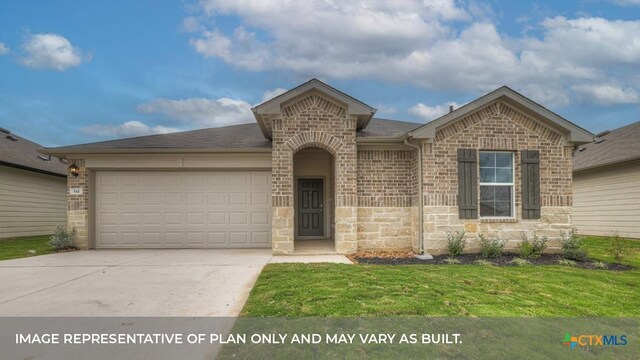 view of front of house with a front yard and a garage