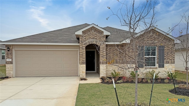 single story home featuring a garage and a front yard