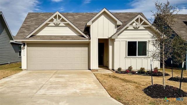 view of front of property with a garage and a front yard