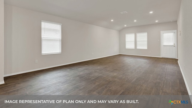 unfurnished room with dark wood-type flooring and vaulted ceiling