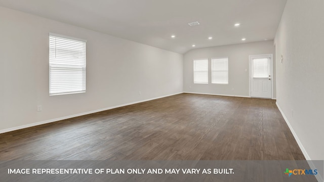 empty room with dark wood-type flooring and vaulted ceiling