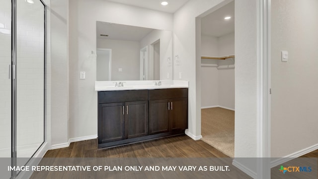 bathroom with vanity, wood-type flooring, and walk in shower