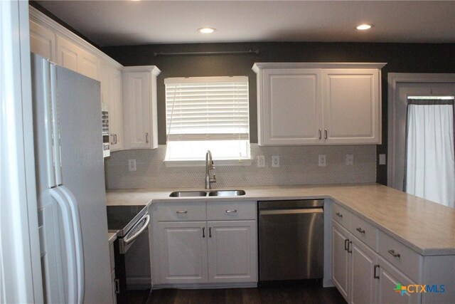 7710 Fallen Pne, Converse, TX 78109 - kitchen with stainless steel dishwasher, freestanding refrigerator, range with electric stovetop, a sink, and a peninsula
