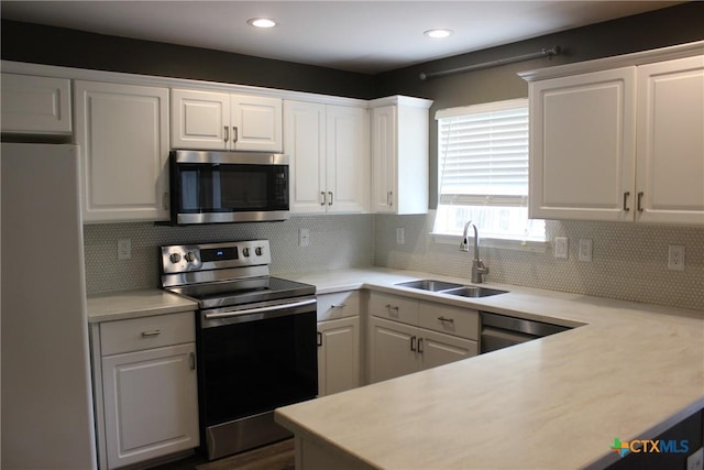 7710 Fallen Pne, Converse, TX 78109 - kitchen with stainless steel appliances, a sink, white cabinetry, light countertops, and tasteful backsplash