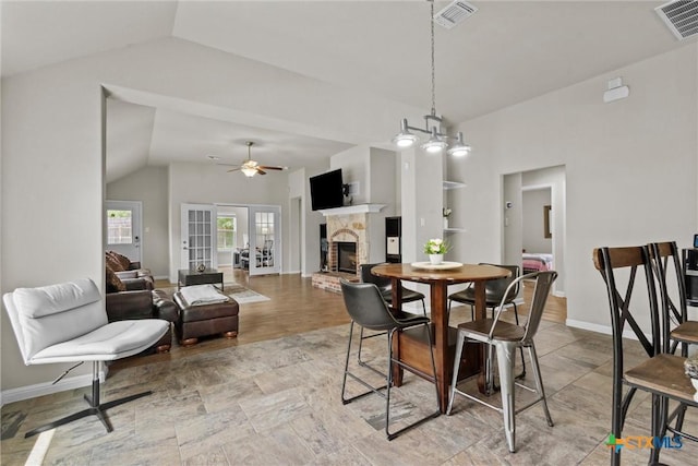 6203 Morganite Dr, Killeen, TX 76542 - dining area with vaulted ceiling, a fireplace, baseboards, and a ceiling fan