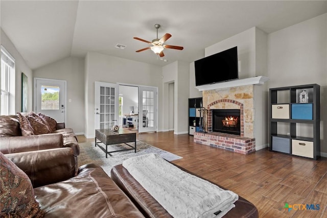6203 Morganite Dr, Killeen, TX 76542 - living room with french doors, wood finished floors, a brick fireplace, ceiling fan, and lofted ceiling