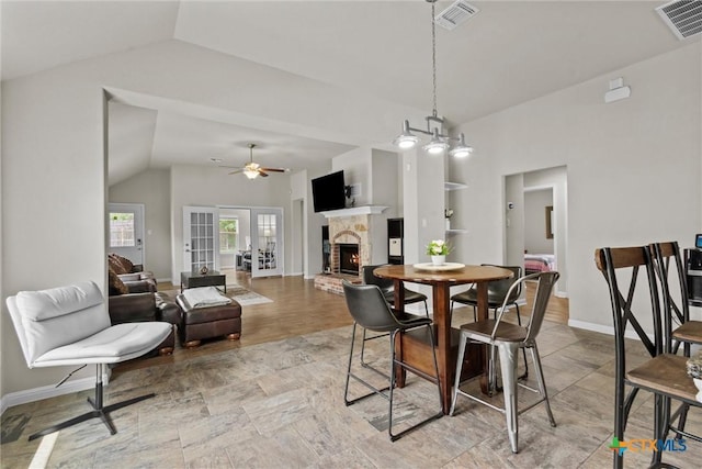 6203 Morganite Dr, Killeen, TX 76542 - dining room featuring lofted ceiling, a brick fireplace, baseboards, and ceiling fan
