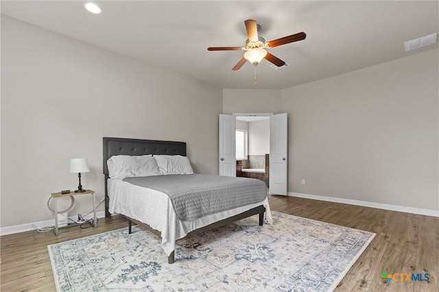6203 Morganite Dr, Killeen, TX 76542 - bedroom featuring baseboards, wood finished floors, a ceiling fan, and ensuite bathroom