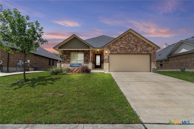 6203 Morganite Dr, Killeen, TX 76542 - view of front facade featuring an attached garage, a yard, concrete driveway, and brick siding