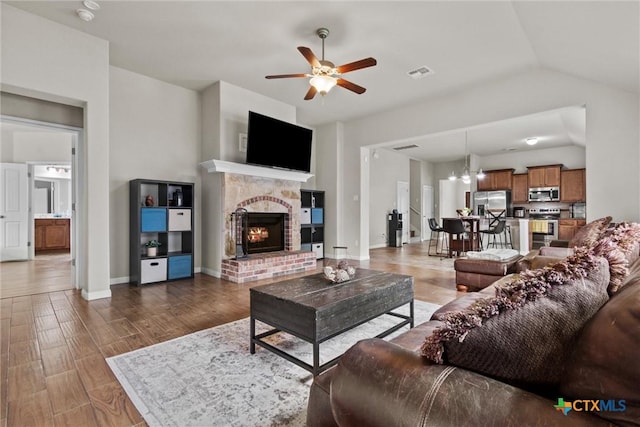 6203 Morganite Dr, Killeen, TX 76542 - living area featuring ceiling fan, a brick fireplace, light wood finished floors, baseboards, and lofted ceiling