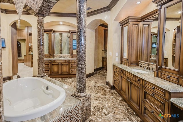 bathroom with vanity, a relaxing tiled tub, and ornamental molding