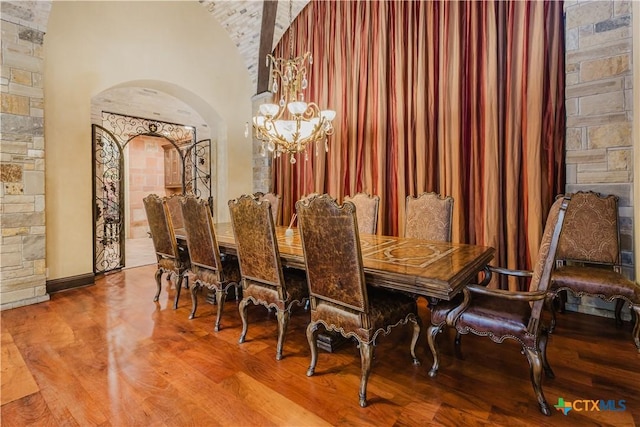 dining area with hardwood / wood-style flooring and a chandelier