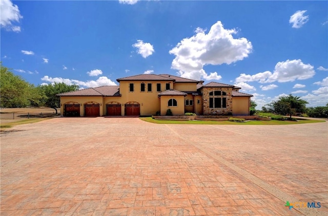 mediterranean / spanish house with a garage