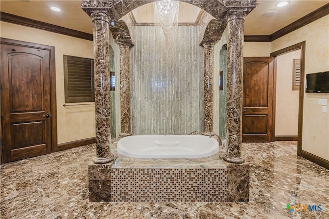 bathroom featuring crown molding, a relaxing tiled tub, and ornate columns