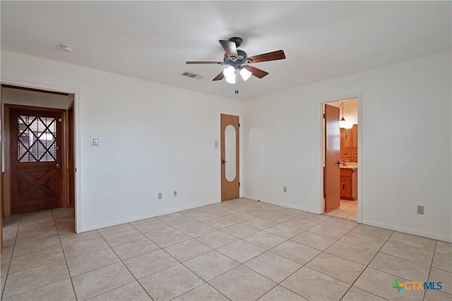 unfurnished room with ceiling fan and light tile patterned floors