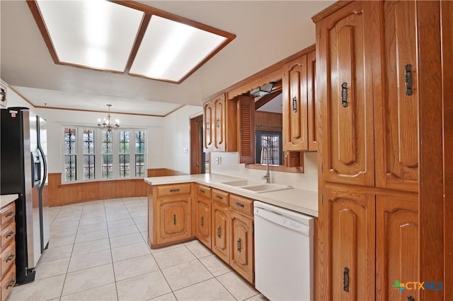 kitchen featuring kitchen peninsula, wooden walls, stainless steel refrigerator with ice dispenser, dishwasher, and sink