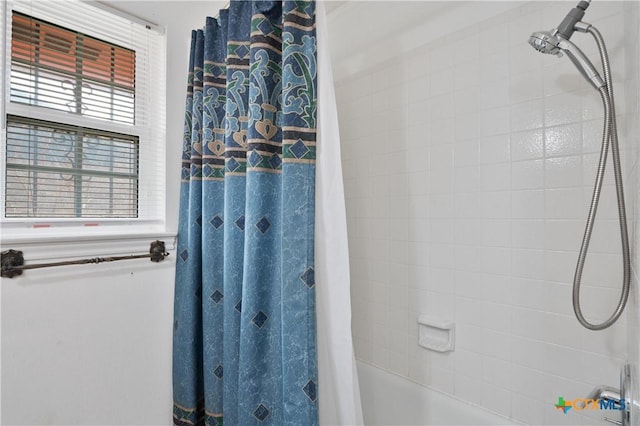 bathroom with shower / tub combo with curtain