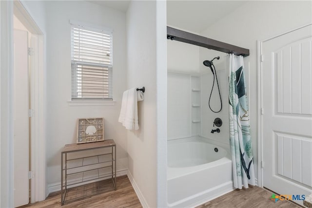 bathroom featuring wood-type flooring and shower / tub combo with curtain