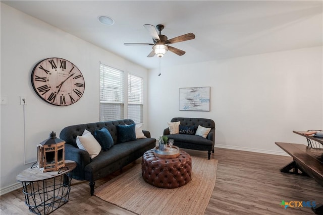 living room with hardwood / wood-style flooring and ceiling fan