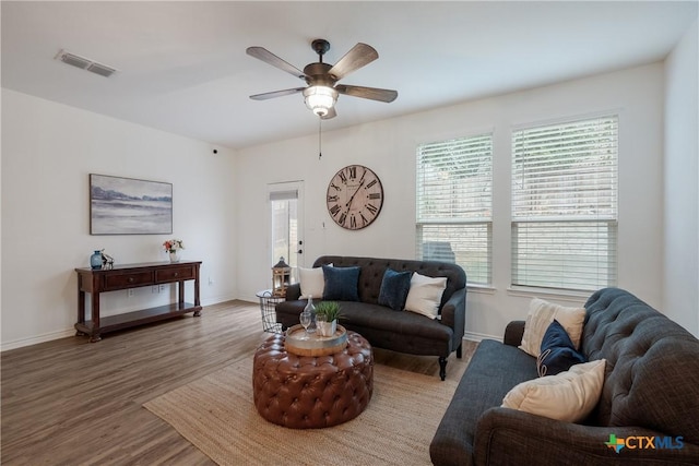 living room with hardwood / wood-style floors, ceiling fan, and a healthy amount of sunlight