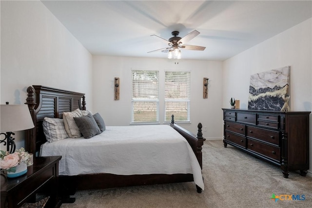 bedroom with ceiling fan and light carpet