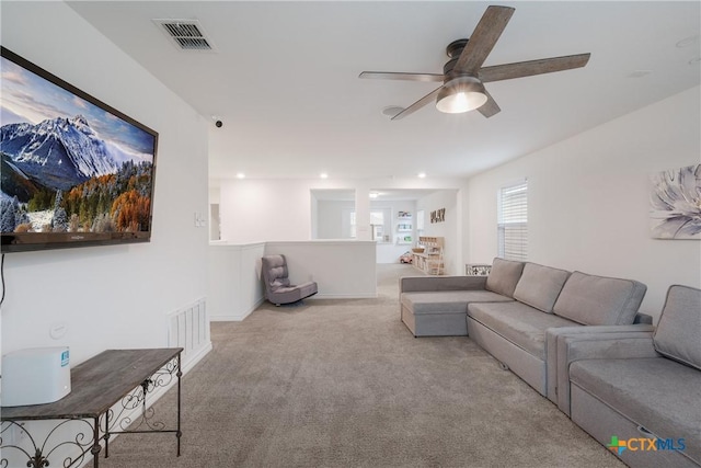 carpeted living room featuring ceiling fan