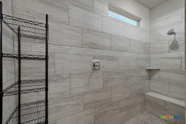 bathroom with a tile shower