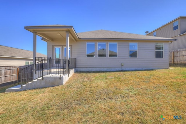 exterior space featuring a front lawn and a patio