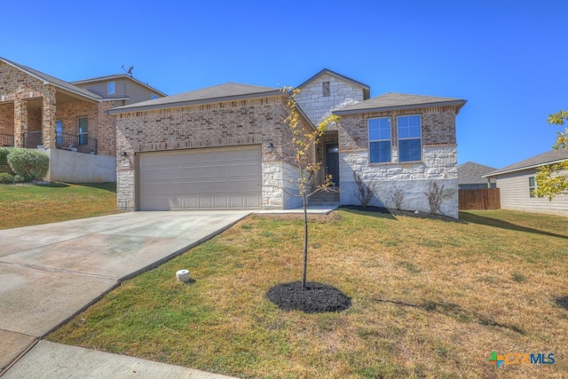 view of front of house featuring a front lawn and a garage