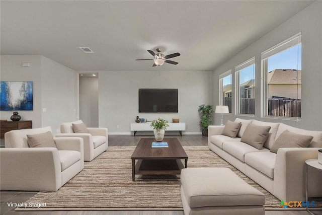 living room featuring hardwood / wood-style floors and ceiling fan